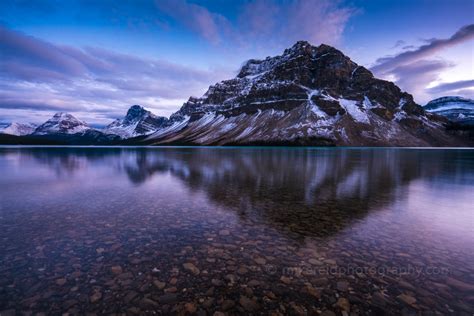 Crowfoot Mountain Reflected In A Calm Bow Lake Towards Dusk Banff