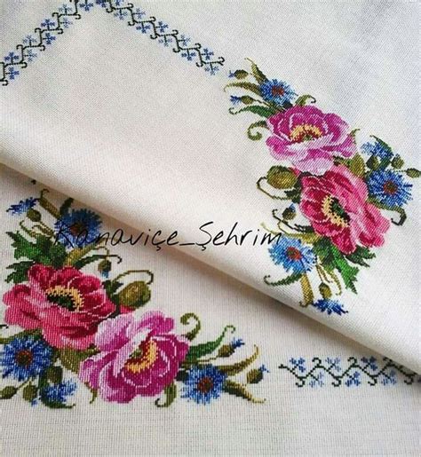 Two White Linens With Pink And Blue Flowers On Them One In The Middle