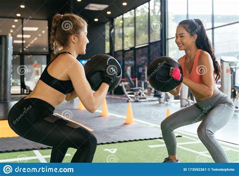 Happy Young Female Athletic People Performing Squat Exercises With