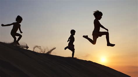 Three Kids Running Down The Hill All Barely In Any Clothes Being