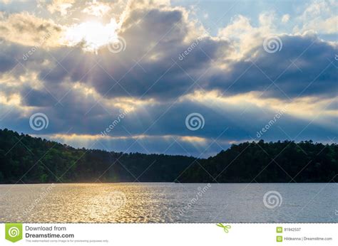 Sun Rays Streaming Thru Dramatic Clouds With Lake View Stock Image