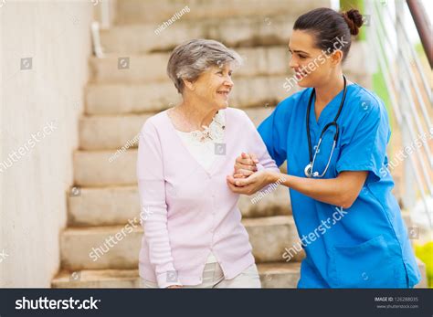 Young Caregiver Helping Senior Woman Walking Stock Photo 126288035