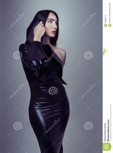 Attractive Tattoo Girl In Black Fetish Laxex Clothes Stock Image