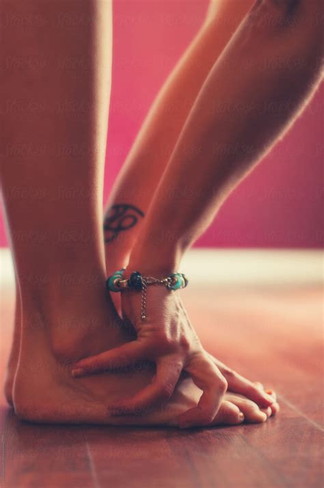 Woman S Hands Touching Feet In Standing Stretch By Stocksy
