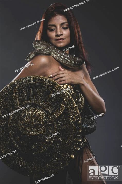 Sensual Tattooed Woman With Big Snake And Iron Corset Stock Photo