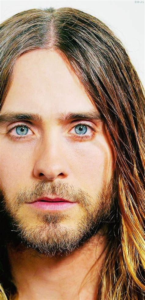 A Man With Long Hair And Blue Eyes