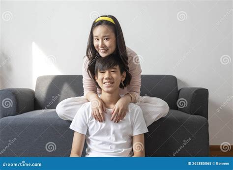 Asian Brother And Sister Hugging With Care And Love Sit On Sofa Stock Image Image Of