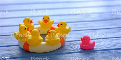 Group Of Yellow Generic Rubber Ducks Sitting On A Large Inflatable Life