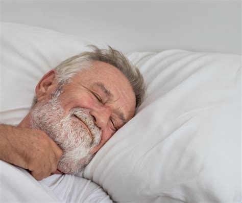 Senior Elderly Man Sleeping Happily With White Blanket In Bedroom