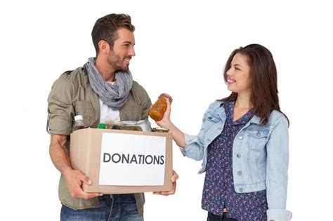Premium Photo Smiling Young Couple With Donation Box