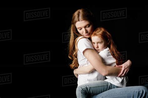 Mother And Little Daughter Hugging Each Other Isolated On Black Stock