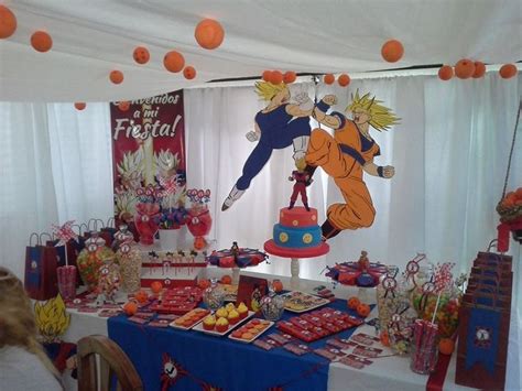 Dragon ball z party with a goku inspire cake, a dessert table with balloons, candies packaged & embellished with stars in orange and blue! Ball birthday, Dragon ball, Ball birthday parties