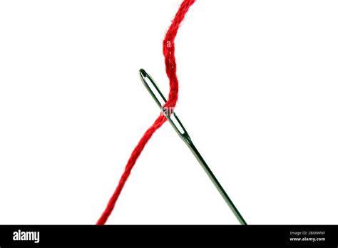 A Needle And Red Thread Over White Stock Photo Alamy