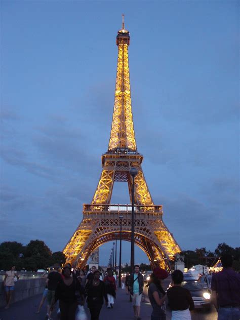 The eiffel tower is a landmark in paris. Night view of Eiffel Tower, Paris, France | The metal ...