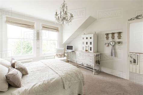 Golden chandelier , white double doors. White, luxury home showcase interior bedroom with ...