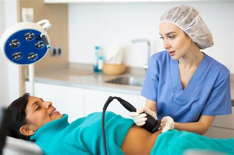 Cosmetologist Performing Ultrasound Cavitation Body Procedure For