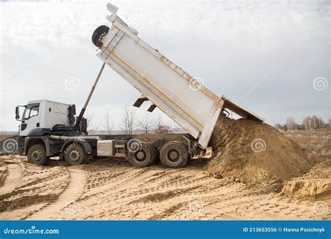 Dump Truck At Work On A Construction Site Soil Unloading Process Stock