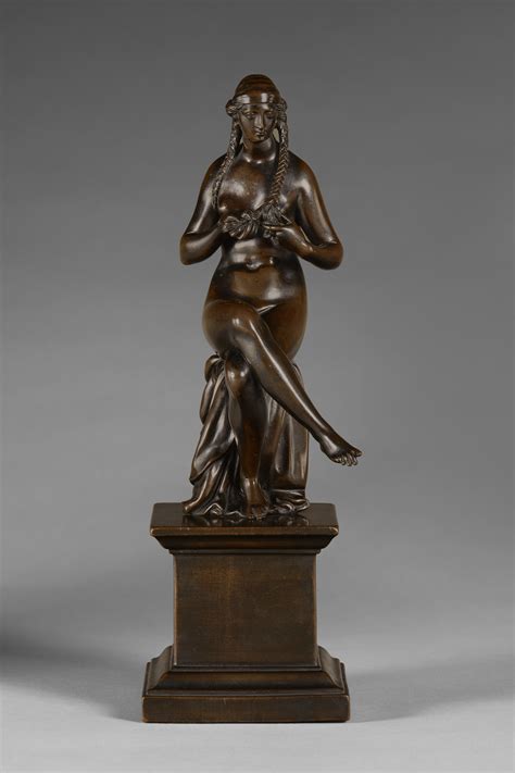A Bronze Figure Of A Seated Nude Woman Braiding Her Hair Auctions