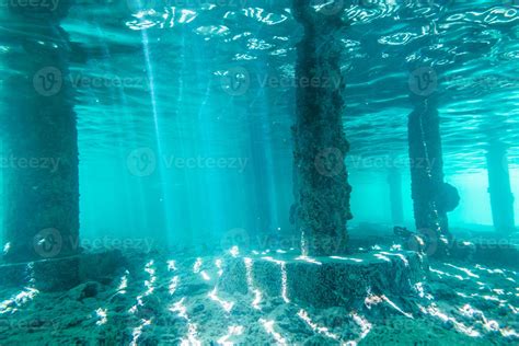 Underwater View Of Under A Pier With Pillars And Sun Light 4296096