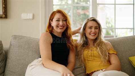 Two Women Smiling Confident Sitting On Sofa At Home Stock Image Image Of Sunlight Enjoy