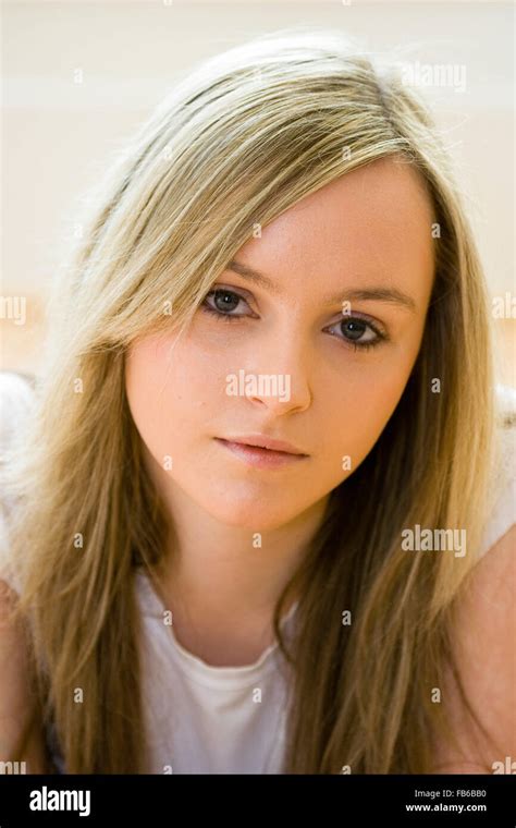 head and shoulder shot of teenage 16 18 years old woman facing with eye contact long blonde