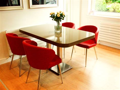 the doris chairs in lipstick red leather match with the doris barstools at the breakfast bar