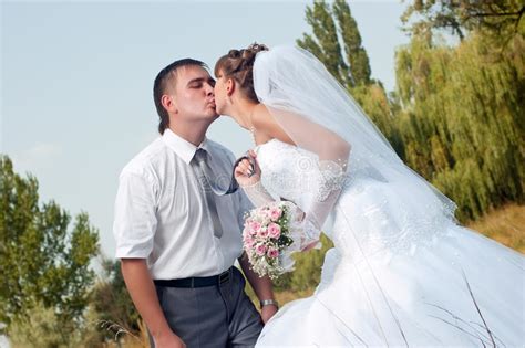 Happy Bride And Groom Outdoors Stock Image Image Of Kissing Gown