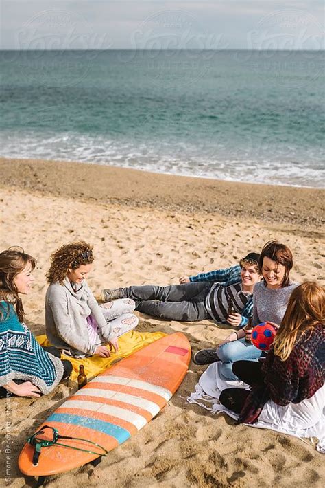 Group Of Friends Relaxing On The Beach By Simone Becchetti For Stocksy United Beach Surf Life