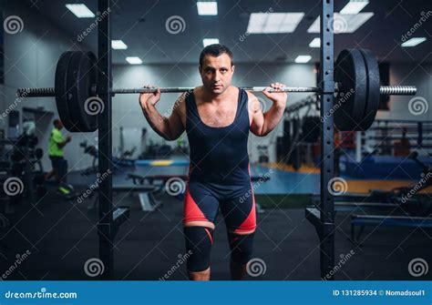 Muscular Athlete Poses At The Stand With Barbell Stock Photo Image Of