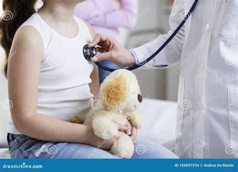 Doctor Checking A Girl S Heartbeat With A Stethoscope Stock Photo