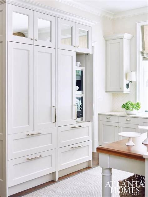 Keep the small space organized by. Lovely kitchen features a wall of square mirrored cabinets ...
