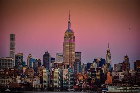 Empire State Building And Midtown Manhatten Skyline At Sun