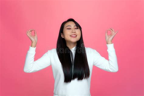 Peaceful Calm Young Asian Girl With Eyes Closed Mudra Om Gesture Meditate Breathing Emotions