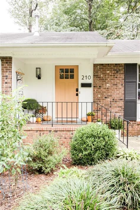 Upgrade Your Curb Appeal Stunning Brick House With Brown Shutters