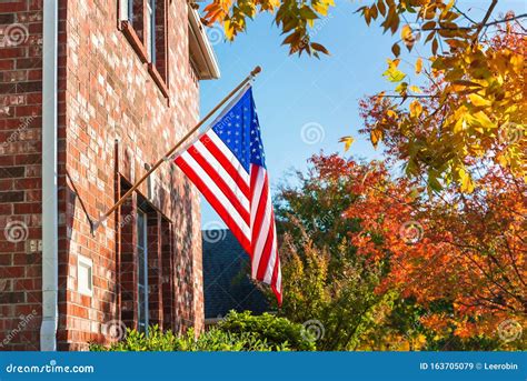 American Flag In Front Of A Brick Home Stock Image Image Of Fall