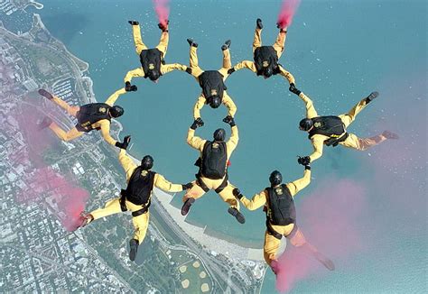 Royalty Free Photo Group Of People Parachuting Over City Near Water