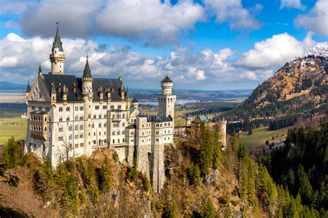 Famous Neuschwanstein Castle In The Background Alps Mountains And Trees