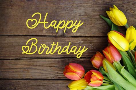 Happy Birthday Text With Fresh Yellow Tulips On Wooden Vintage Rustic