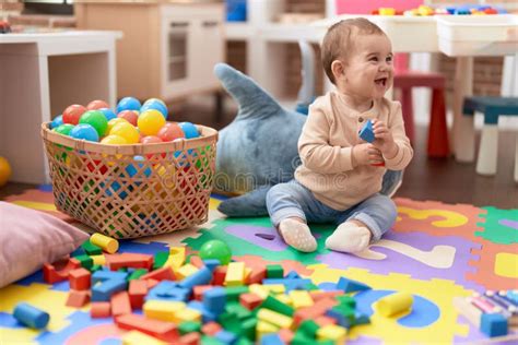 Adorable Toddler Playing With Wooden Construction Blocks Sitting On