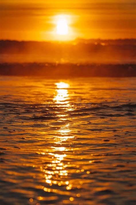 Colorful Ocean Beach Sunrise With Deep Blue Sky And Sun Rays Stock