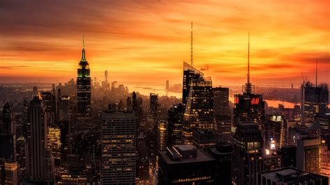 City With High Rising Buildings Under Yellow Sky During Sunset Hd New