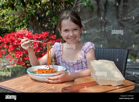 Seven Year Old Girl Is Eating Spaghetti Outside Stock Photo Alamy