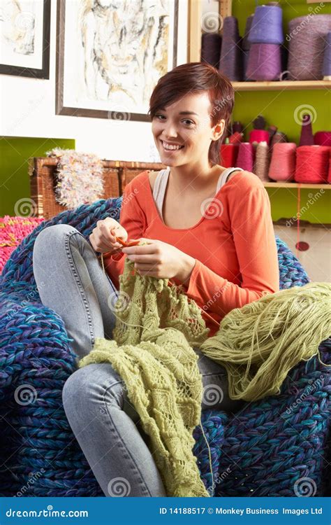 Young Woman Sitting In Chair Knitting Royalty Free Stock Photography