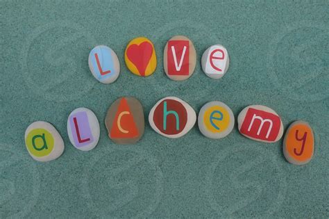 Love Alchemy Text Composed With Creative Carved And Colored Stones Over