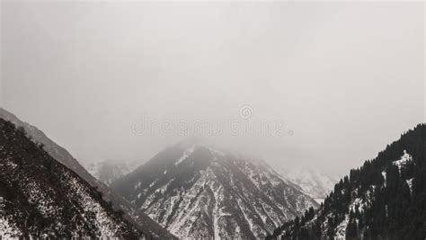 Mountain Peaks In Fog And Clouds Snow Covered Mountain Slopes Hidden