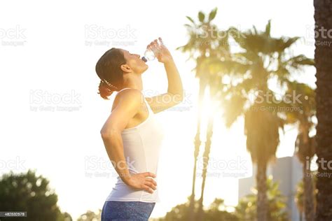 Sports Woman Drinking Water From Bottle After Workout Stock Photo