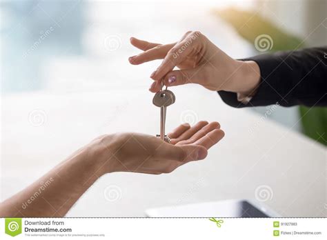 Female Hand Giving Keys To Male Client Buying Renting Apartment Stock