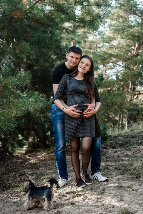 Pregnant Woman And Her Husband Lovely Hugging On Nature