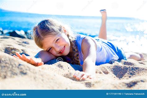 Blond Child Lying On Sandy Beach Of Sea Coast Stock Photo Image Of