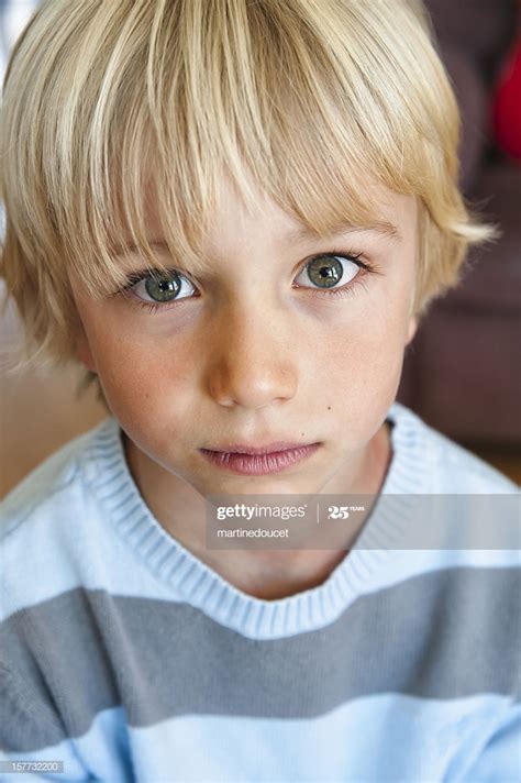 Search, discover and share your favorite blonde hair boy gifs. Portrait Of A Cute And Serious Young Boy High-Res Stock ...